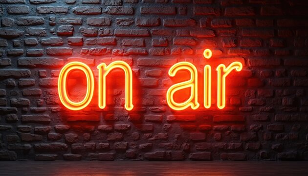 Bright neon orange on air sign glows against a dark brick wall backdrop. This illuminated text provides a retro, inviting ambiance. Perfect for broadcasting, entertainment, or studio promotions.