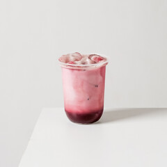 Red velvet milk drink with ice in a plastic cup on a clean white background. Minimal product photo...