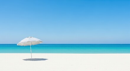 Serene white umbrella on a pristine tropical beach with turquoise ocean