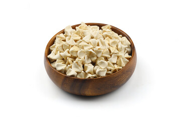 handmade manti (turkish ravioli type dumplings) on wooden bowl, before cooking. isolated on white background.