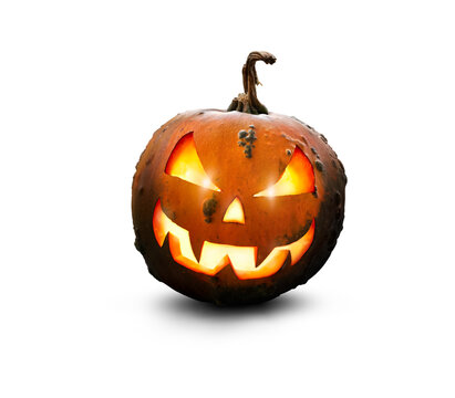 A lit green and orange spooky halloween pumpkin, Jack O Lantern with evil face and eyes isolated against a transparent background