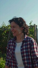 A woman with a joyful expression outdoors.