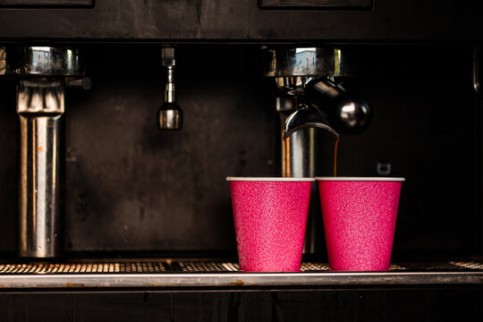 Coffee making machine in coffee van with shot pouring into paper cups