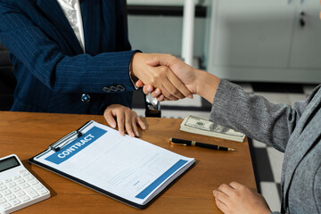 Close up shake hands, Considering buying a home, investing in real estate. Broker signs a sales...