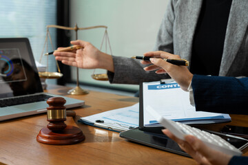 Teamwork of business lawyer meeting working hard about legal legislation in courtroom to help their...