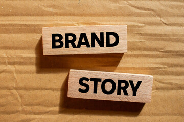 Brand story message written on wooden blocks on cardboard background. Conceptual brand story symbol. Copy space.