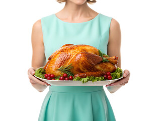 Woman in a blue dress holding a platter with a roasted turkey garnished with greens and cranberries