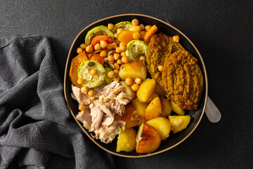 A nutritious breakfast spread showcases baked sweet potato, colorful vegetables, tender chicken...