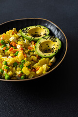 Colorful salad features boiled egg, tender chicken breast, and fresh vegetables like potatoes,...
