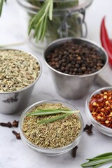 Different aromatic spices on white table, closeup