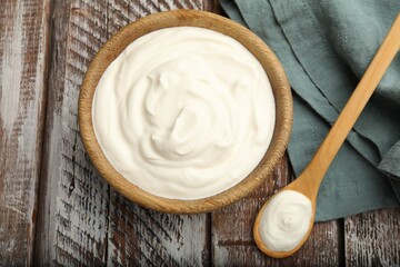 Tasty sour cream on wooden table, flat lay