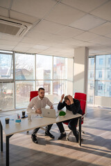 Two Caucasian men solve problems at work. 