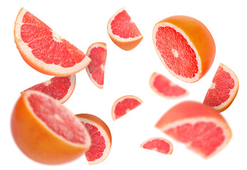 Fresh grapefruits swirling in air against white background