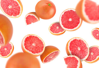 Fresh grapefruits swirling in air against white background