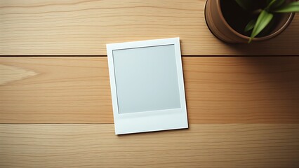 A vintage polaroid frame on a wooden table, captured from an overhead angle in minimalist style.
