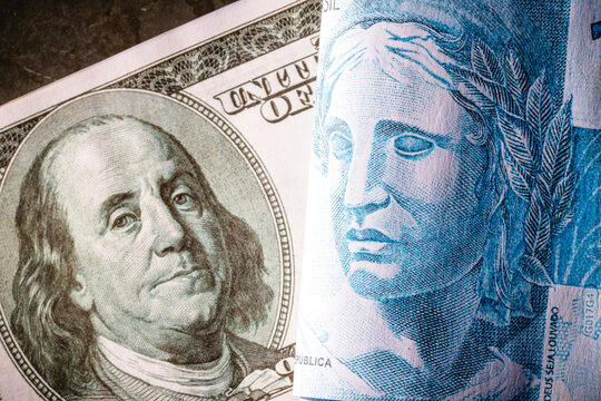 Brazilian money, real banknotes and dollar bills, financial crisis, dark image, financial crisis, economic tension
