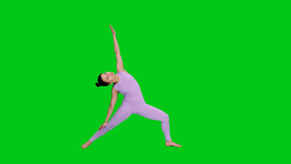 Fototapeta premium Athletic girl in bodysuit doing yoga warrior pose on green chroma key background