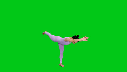 Young athletic woman in bodysuit practicing yoga warrior pose on green chroma key background