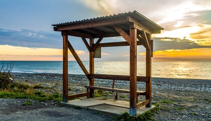 Wooden bus stop at sunset beach