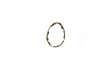 Scorched oval paper hole, charred rim and clean center, isolated on white background with clipping...