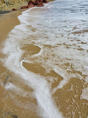 Obraz premium Wave foam on the beach