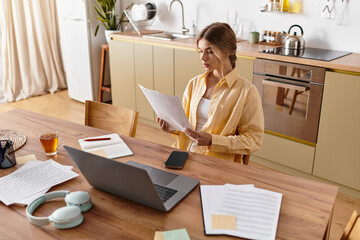 A young woman sits peacefully at her table, reviewing documents in her cozy home.