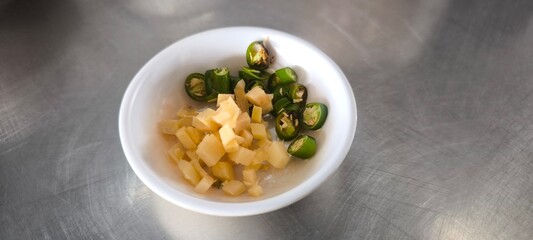 Sliced ??chilli and ginger in a white bowl