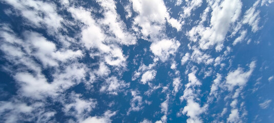 Sky is blue and clear with no clouds. The sky is very bright and the sun is shining. Blue sky with scattered white clouds creating a serene and peaceful atmosphere.