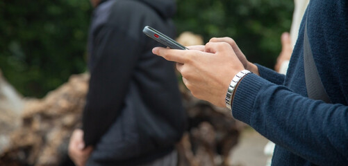Man using smartphone in outdoors.
