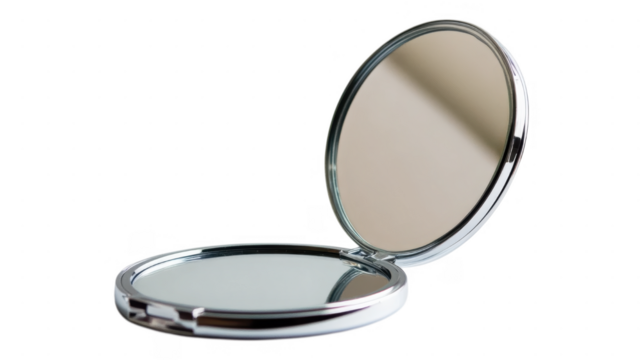 Compact mirror reflecting light against transparent background creates elegant visual contrast
