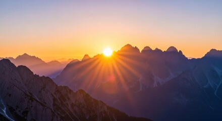 Breathtaking Sunrise Over Majestic Mountain Peaks with Vibrant Colors and Sunbeam Rays Illuminating the Scenic Landscape at Dawn