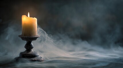 Burning candle in smoky setting