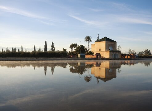 The Menara gardens, basin and minzah, a palace-like pavilion, High Atlas mountains behind, Morocco
