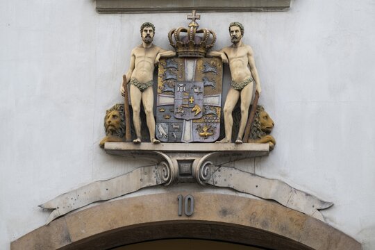 Coat of arms with crown and two men, Stormgade 10, Copenhagen, Denmark