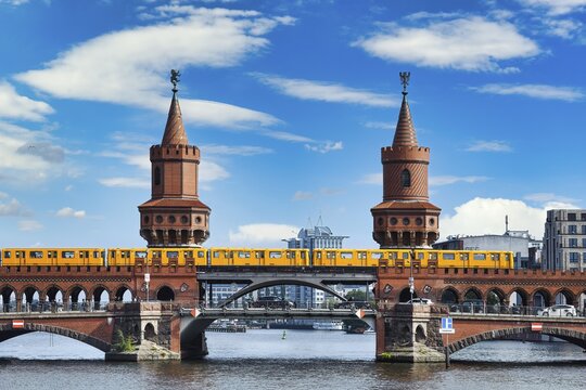 Yellow S-Bahn on Oberbaum bridge over the Spree river, Berlin, Germany