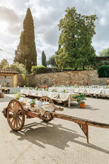 Charming Italian courtyard with string lights, cypress and magnolia tree. Rustic wedding in Tuscany...