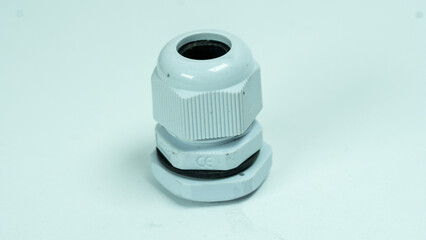 White plastic cable gland on light background