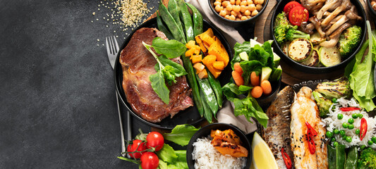 Table scene of various delicious foods. Healthy, family dinner.