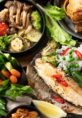 Table scene of various delicious foods. Healthy, family dinner.