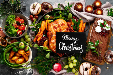 Festive dinner table with roasted chicken. Christmas family dinner.