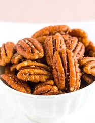 Spiced pecans in white bowl