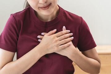 Close-up woman touching chest feeling pain heart attack symptom