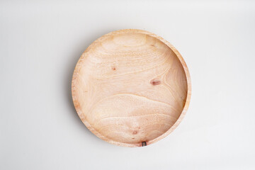 Top view of empty round wooden plate on white background, minimal kitchenware and eco-friendly tableware concept.