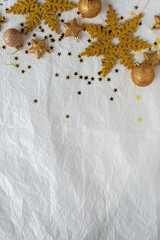 christmas decorations on paper texture background, gold snowflake, Christmas ball, gold glitter.