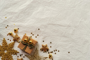 Gold Christmas theme decorations on paper texture background,  Christmas tree, gold presents box, decorative gold stars and gold gift box.