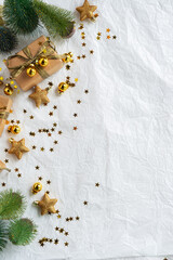 Gold Christmas theme decorations on paper texture background,  Christmas tree, gold presents box, decorative gold stars and Christmas ball. 