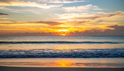 Obraz premium Sunset over calm ocean waves