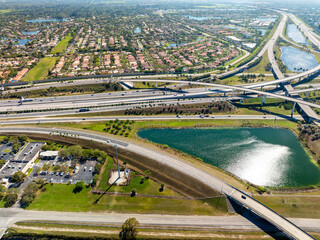 Wide multilane highway crossroads in Miami, Florida with fast driving cars. Above view of USA...