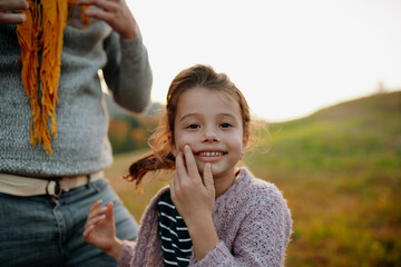 Portrait of beautiful young girl on walk in autumn nature, spending sunday outdoors.