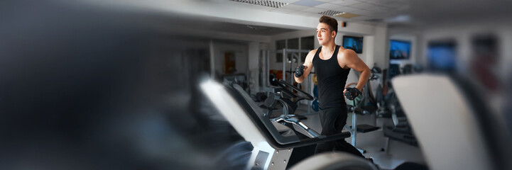 Man Running on Treadmill in Gym Wide Banner
